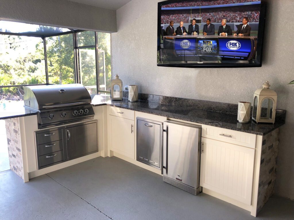 L shaped outdoor kitchen with grill and mini fridge
