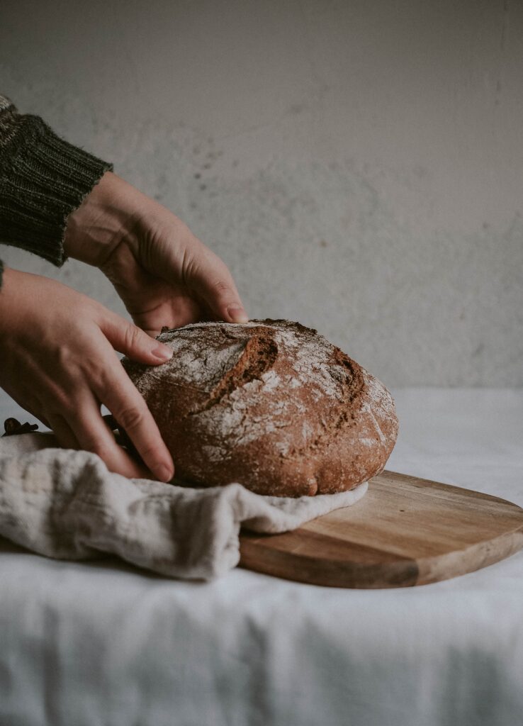 person holding sourdough loaf