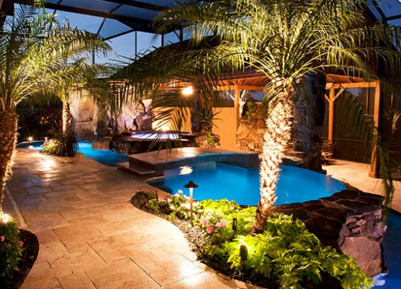 Outdoor lighting with pool in background
