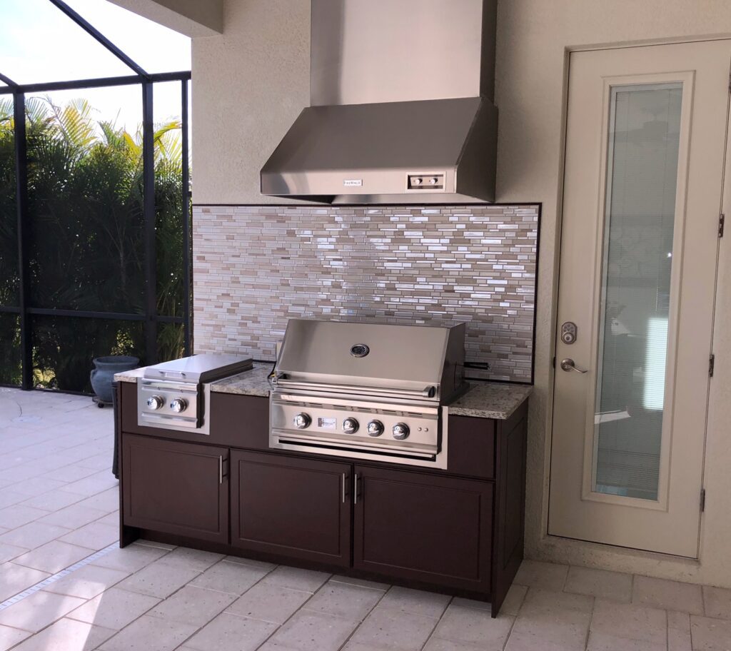 brown kitchen with vent hood and summerset grill 