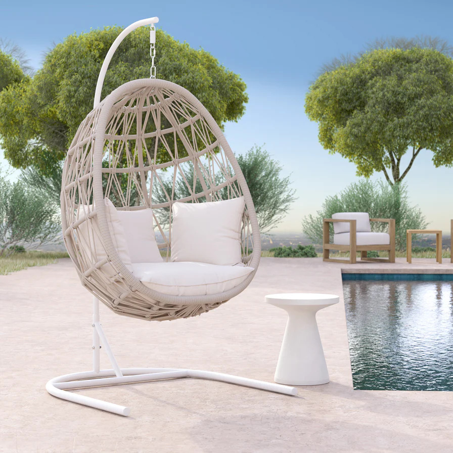 hanging egg shaped chair next to pool 