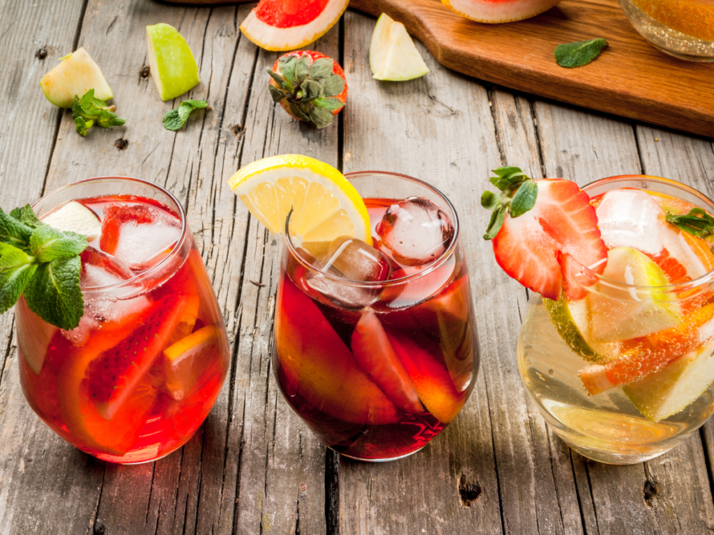 colorful summer drinks in glasses with fruit 