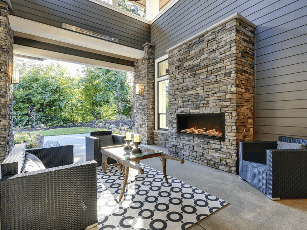 brick fireplace in outdoor space with Amantii Electric Fireplaces