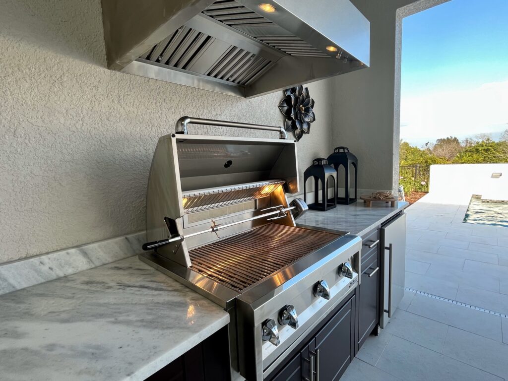 Artisan grill and fridge in outdoor kitchen