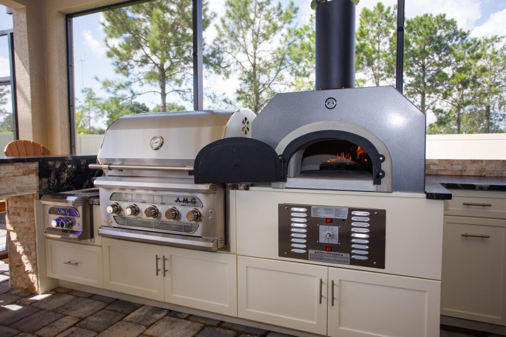 custom outdoor kitchen with pizza oven and Endura cabinets 