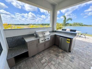 Outdoor kitchen with cabinets and Coyote grill