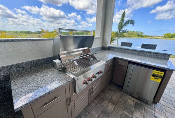 Outdoor kitchen with cabinets and Coyote grill